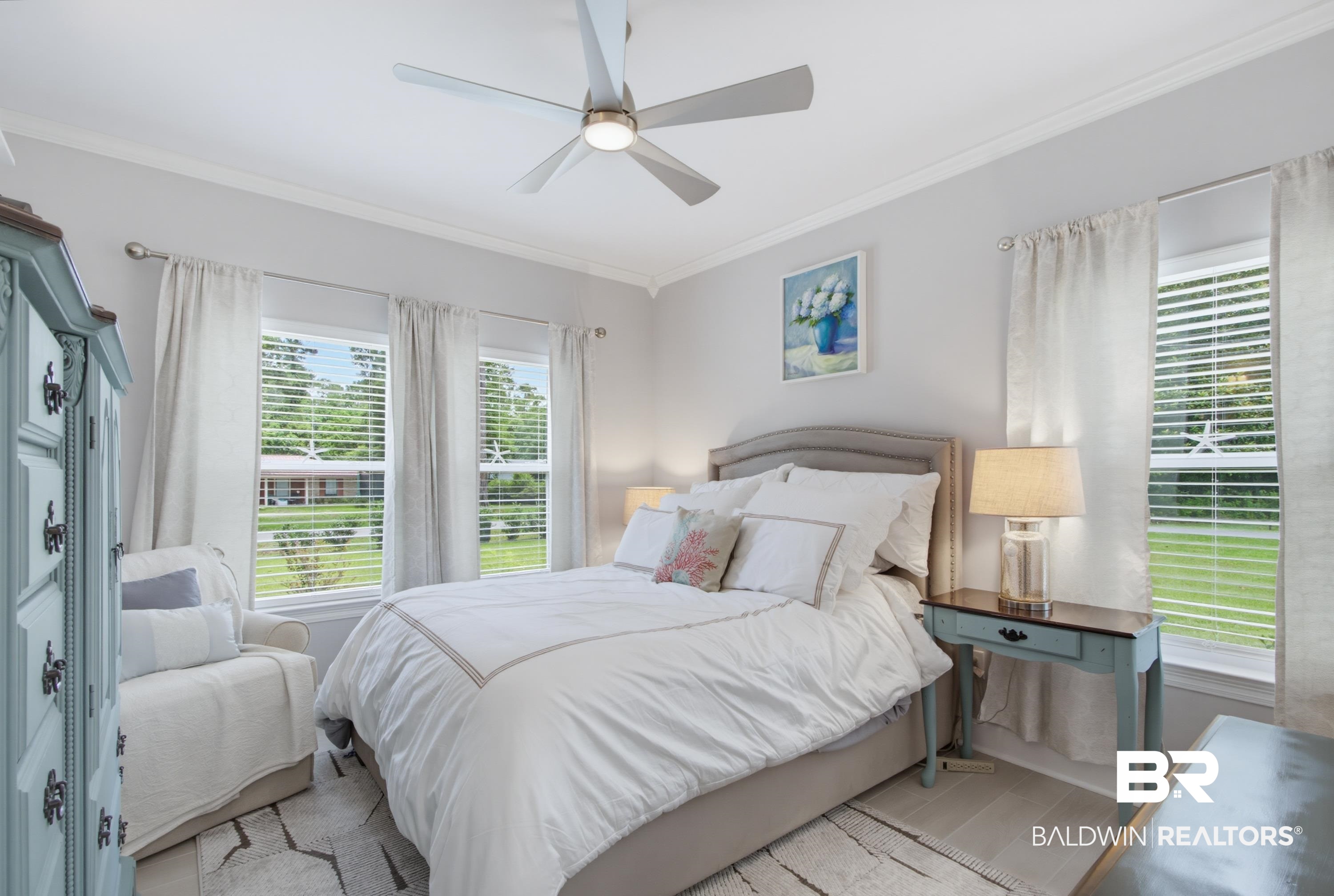 7472 Coopers Landing Road Foley, AL 36535 - Photo 17 of 40 Bedroom featuring a ceiling fan with integrated lighting, wood-finish flooring, and multiple windows with blinds and curtain rods
