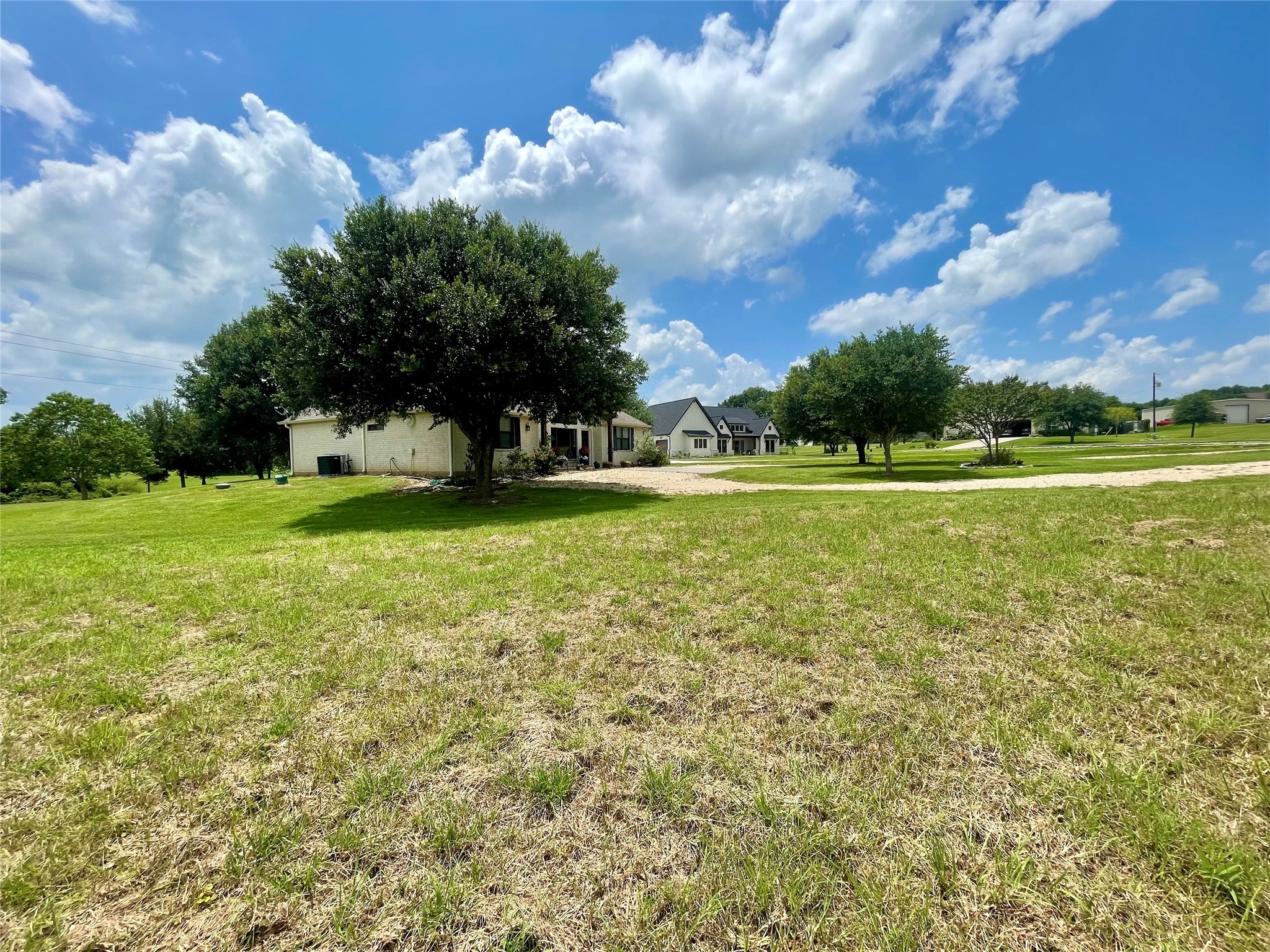 3395 Success Court Brenham, TX 77833 - Photo 2 of 10 a view of a big yard with a large trees