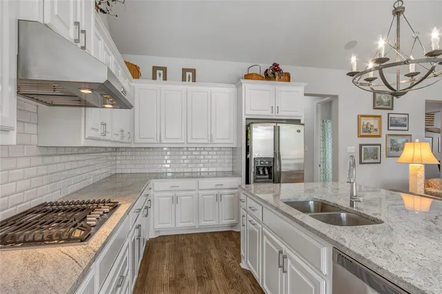 a kitchen that has a lot of cabinets in it