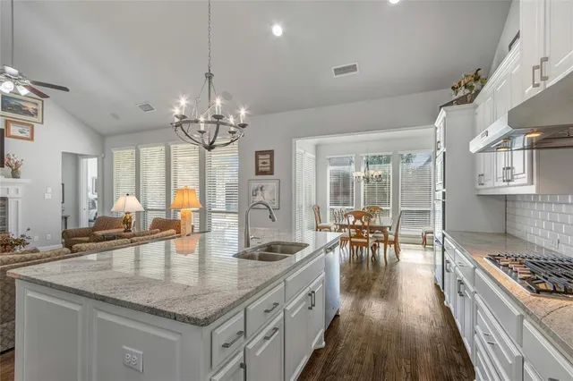a kitchen with sink stove and cabinets