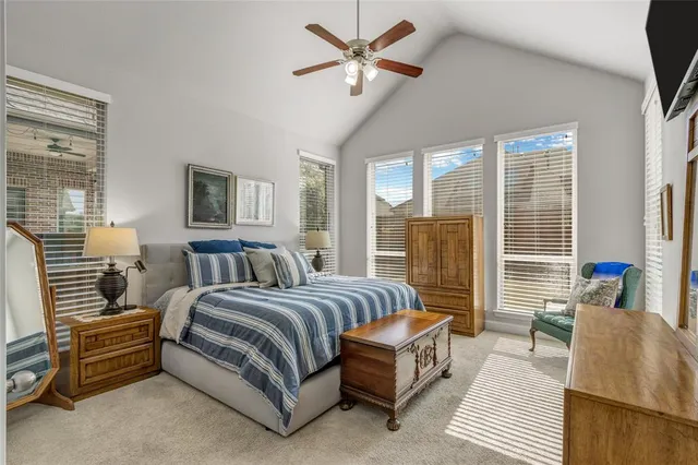 a spacious bedroom with a bed a couch and a large window