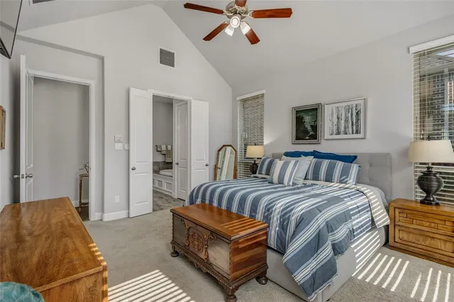 a bedroom with a bed and ceiling fan