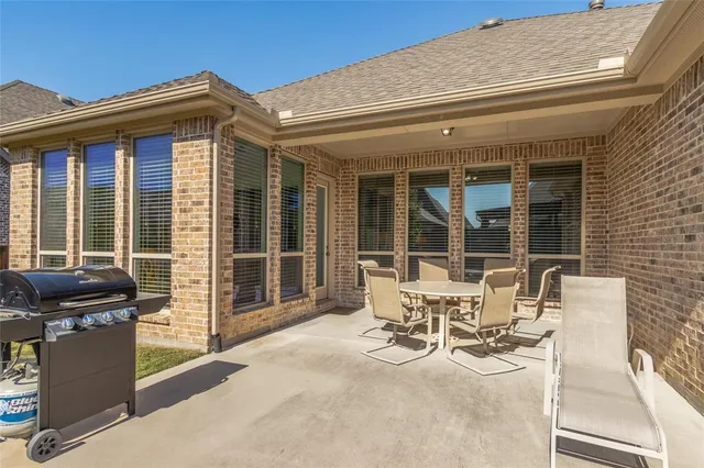 a view of a patio with table and chairs and wooden floor