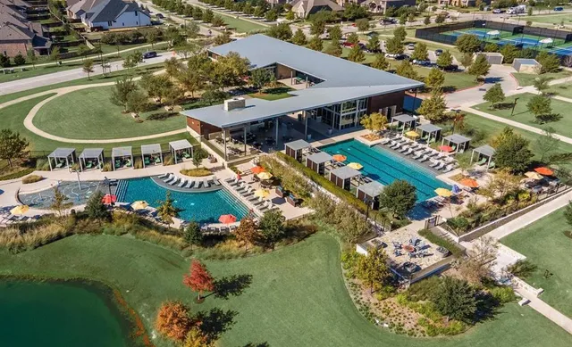 an aerial view of a house with a swimming pool yard and outdoor seating