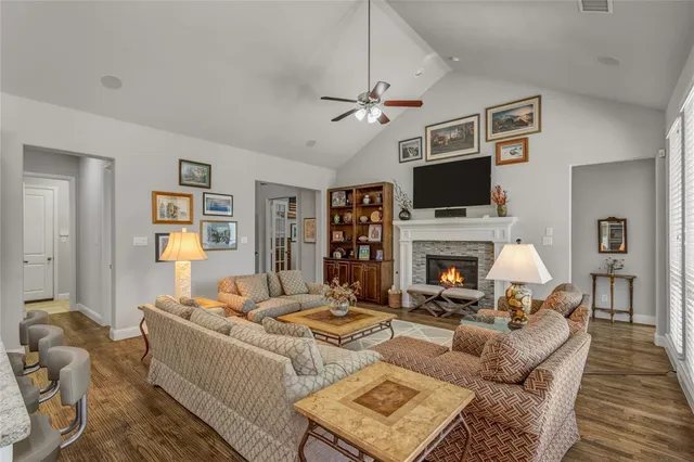 a living room with fireplace furniture and a flat screen tv