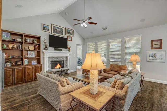 a living room with furniture fireplace and a flat screen tv
