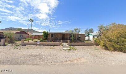 1245 North Thompson Avenue Ajo, AZ 85321 - Photo 1 of 17 a view of a backyard with sitting area and furniture