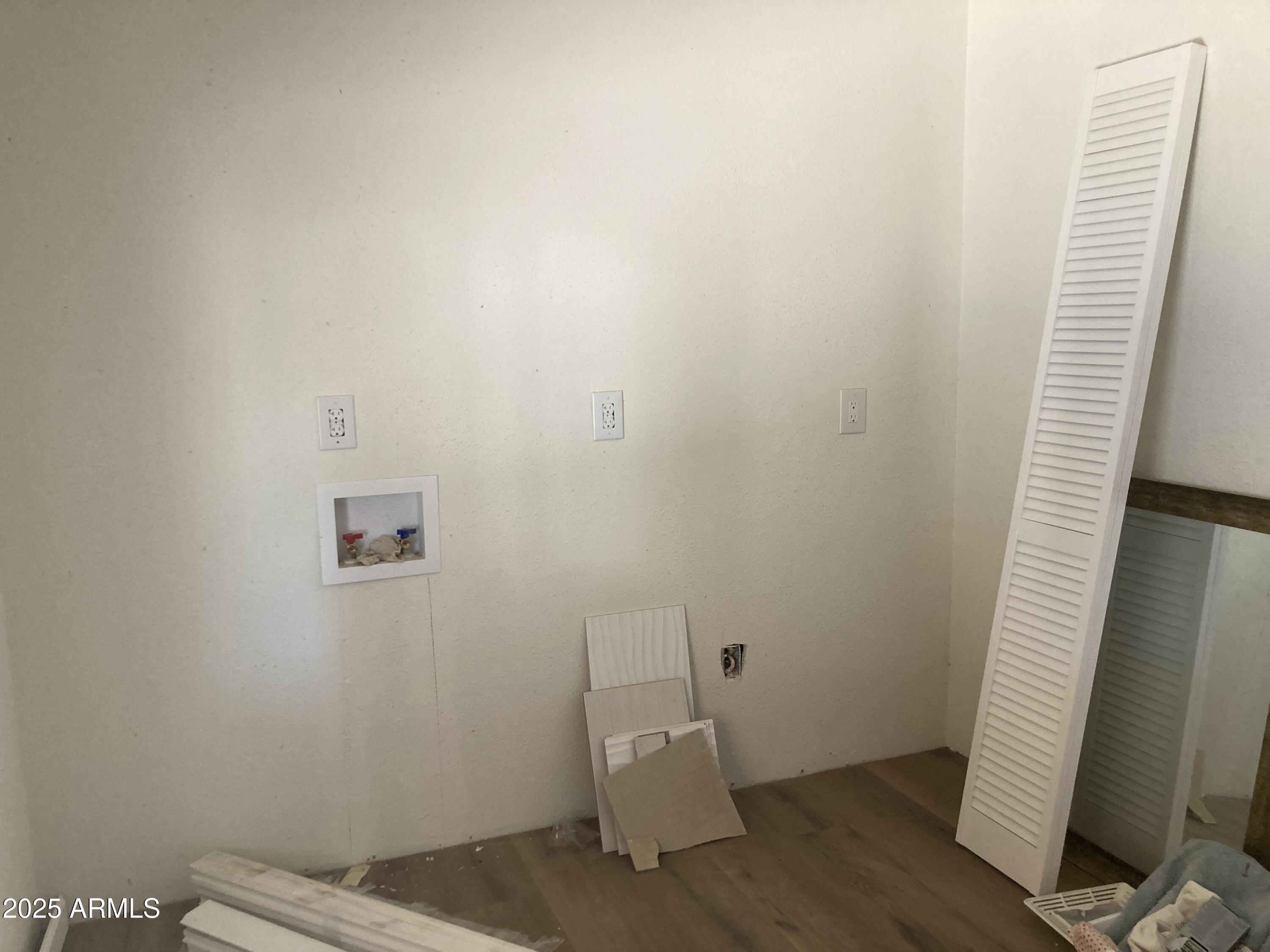 1245 North Thompson Avenue Ajo, AZ 85321 - Photo 12 of 17 a view of an empty room with wooden floor