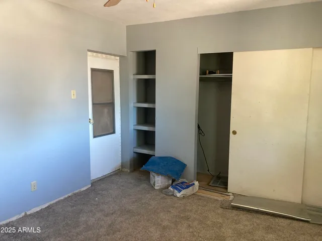 a bedroom with a bed and a mirror