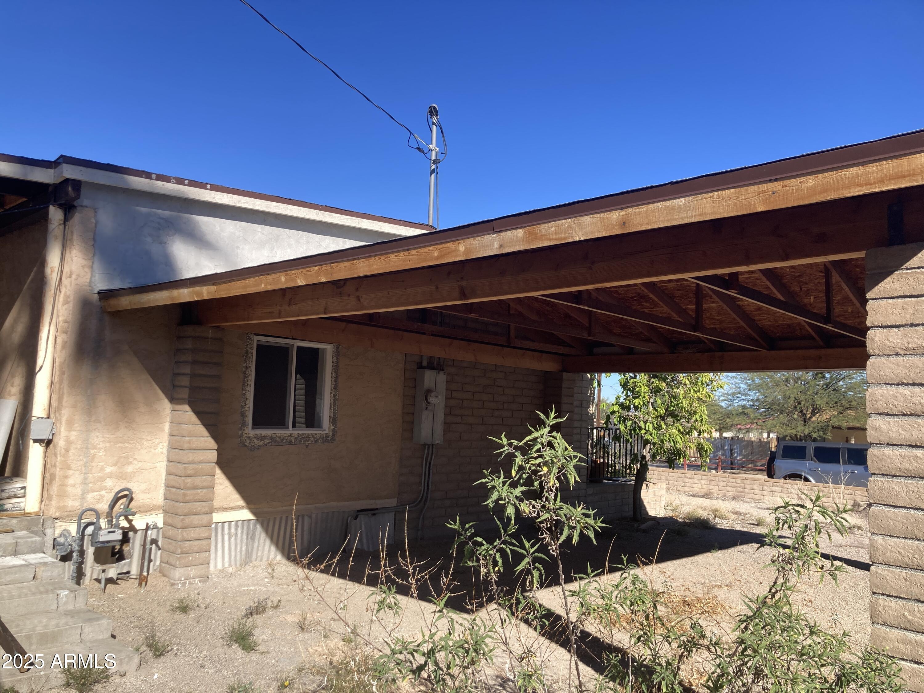 1245 North Thompson Avenue Ajo, AZ 85321 - Photo 3 of 17 a view of a backyard with a patio