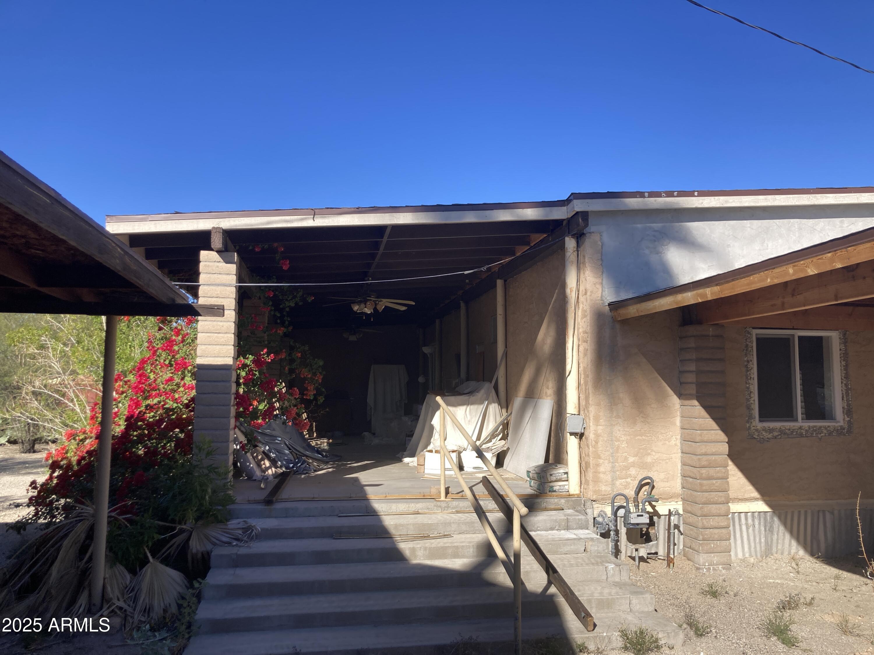 1245 North Thompson Avenue Ajo, AZ 85321 - Photo 4 of 17 a view of a patio with table and chairs potted plants