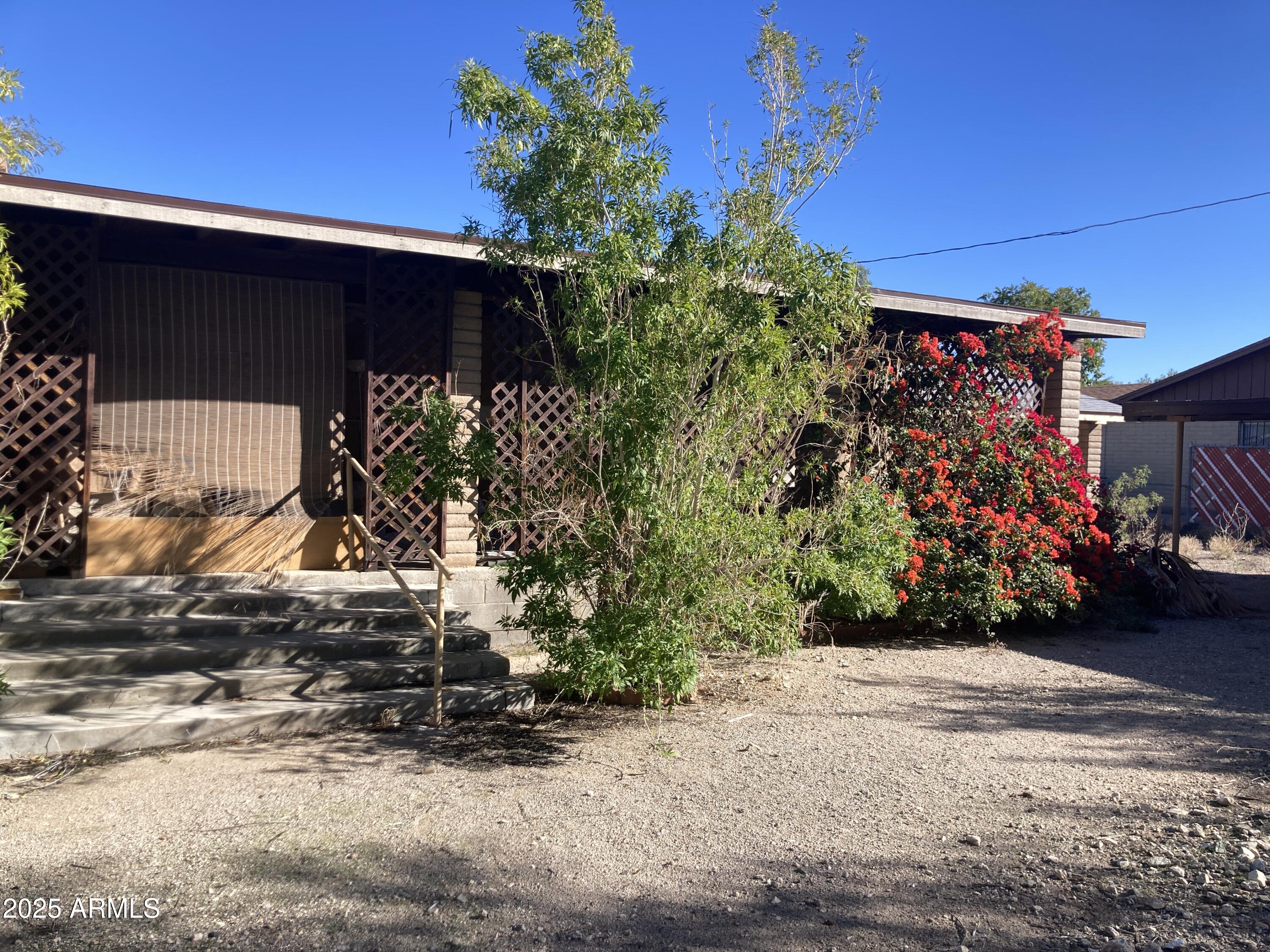 1245 North Thompson Avenue Ajo, AZ 85321 - Photo 6 of 17 a front view of a house with a yard