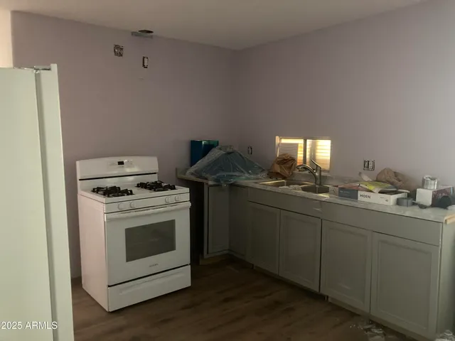 a kitchen with a stove and a refrigerator