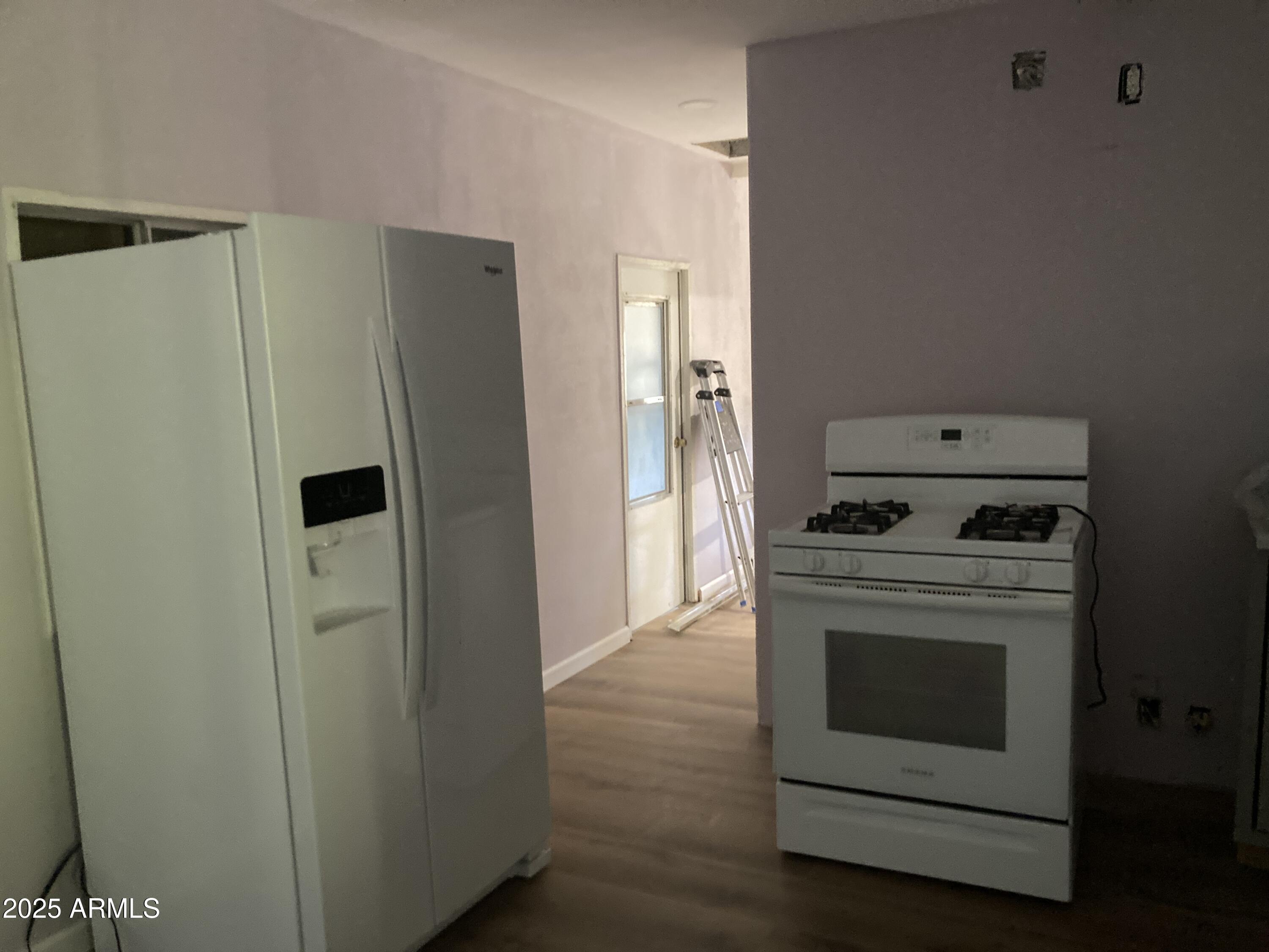 1245 North Thompson Avenue Ajo, AZ 85321 - Photo 8 of 17 a kitchen with a stove and a refrigerator