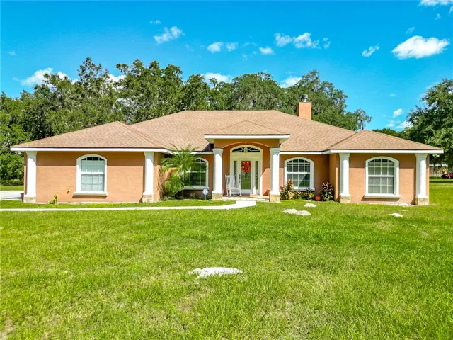 a front view of a house with outdoor seating