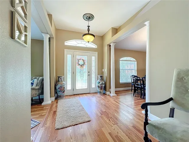 a view of a dining room with furniture and chandelier