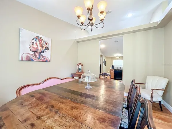 a kitchen with stainless steel appliances kitchen island granite countertop a refrigerator a stove and a sink with wooden floor