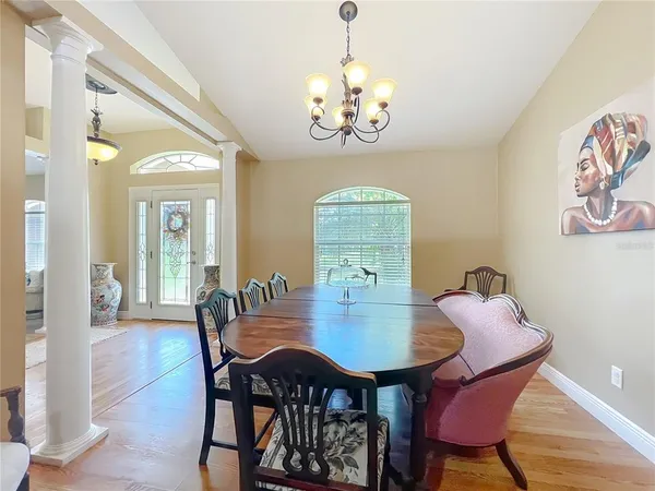 a kitchen with stainless steel appliances kitchen island granite countertop a table chairs and a refrigerator