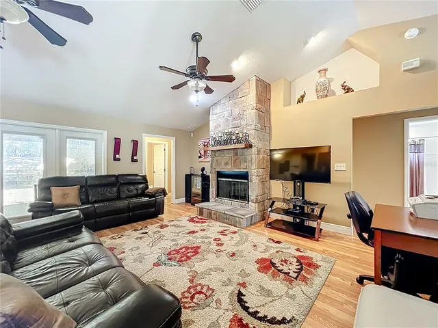 a bedroom with a bed and a flat tv screen on dresser