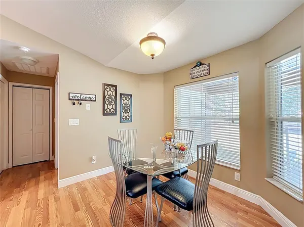 a bedroom with a bed and a table in it with window