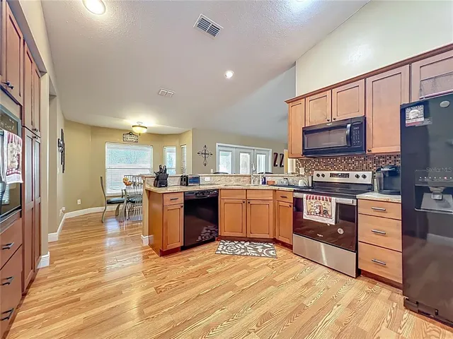 a aerial view of a house with swimming pool next to a big yard