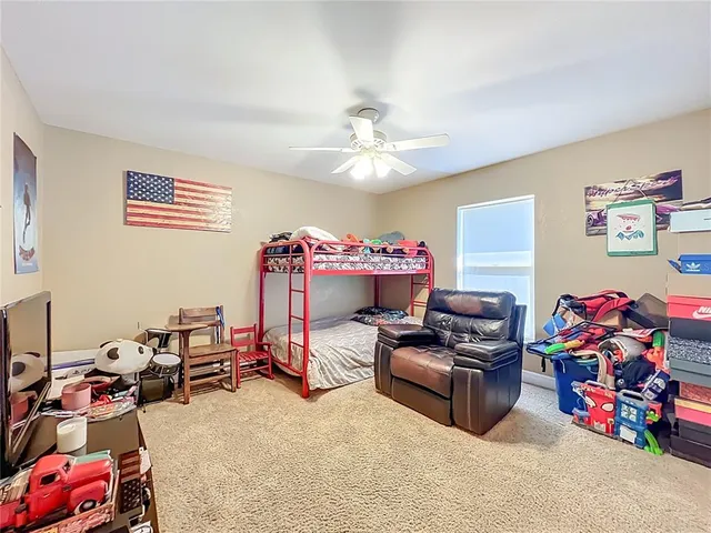 a view of a lush green forest with a house in the background