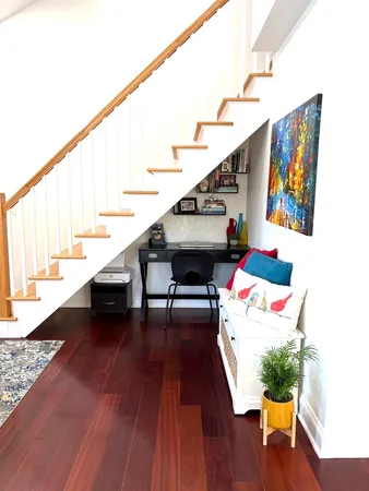 a living room with furniture and stairs
