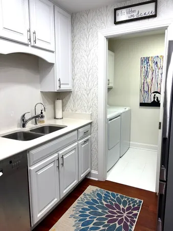 a kitchen with stainless steel appliances white cabinets and a sink