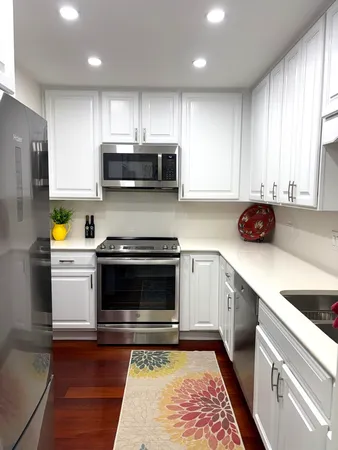 a kitchen with a sink a microwave and cabinets