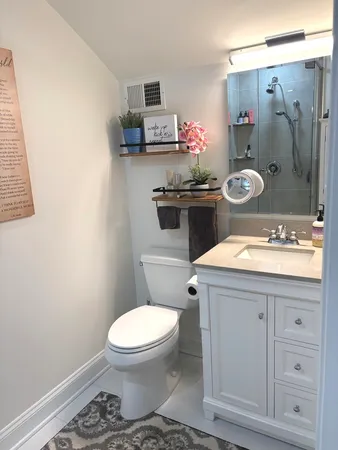 a bathroom with a sink toilet and shower