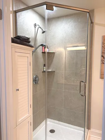 a bathroom with a shower and a glass door