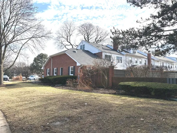 a view of a house with a yard covered with snow in front of house