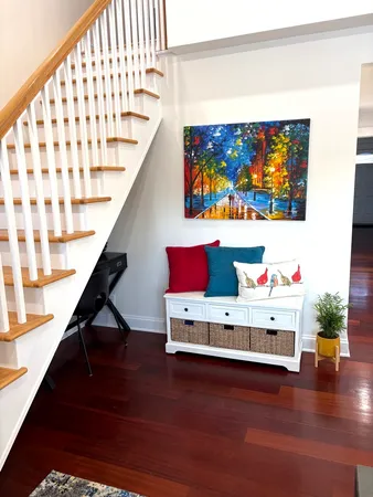 a living room with furniture and stairs