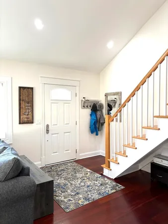 a living room with furniture and stairs