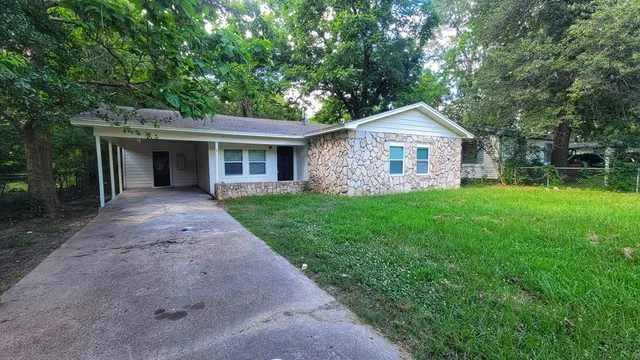 a front view of house with yard and green space