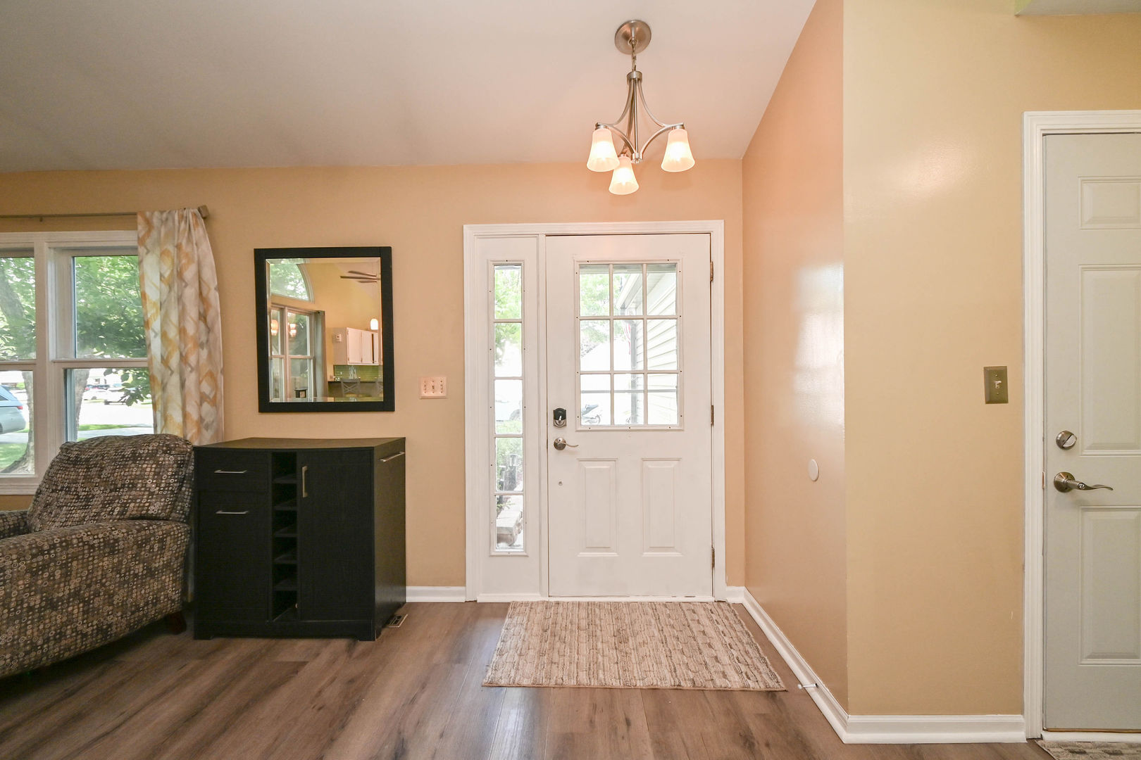 1333 Regency Lane Round Lake, IL 60073 - Photo 4 of 31 a view of a livingroom with wooden floor and kitchen space