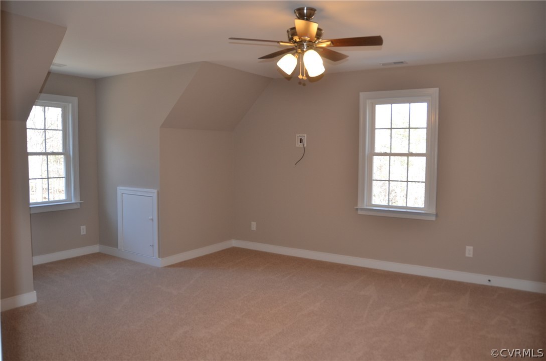 1128 Signboard Road Bumpass, VA 23024 - Photo 14 of 20 an empty room with windows and fan