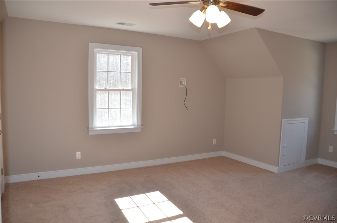 1128 Signboard Road Bumpass, VA 23024 - Photo 18 of 20 an empty room with a chandelier fan and windows
