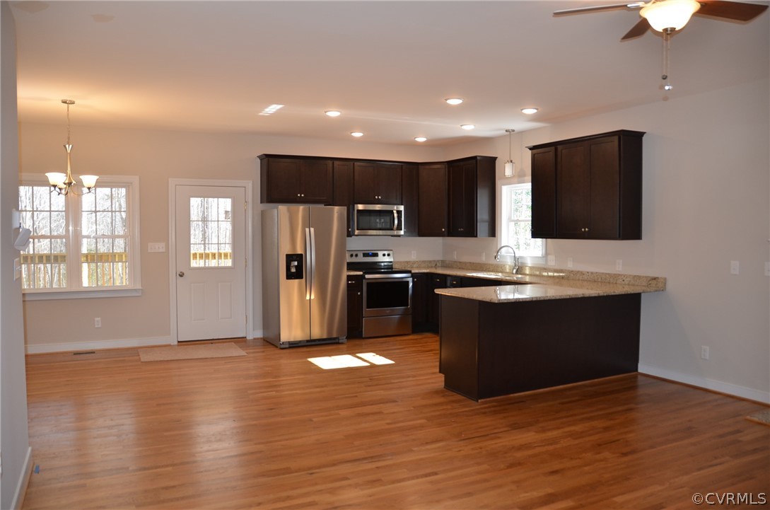 1128 Signboard Road Bumpass, VA 23024 - Photo 7 of 20 a large kitchen with stainless steel appliances granite countertop a stove a sink and a microwave