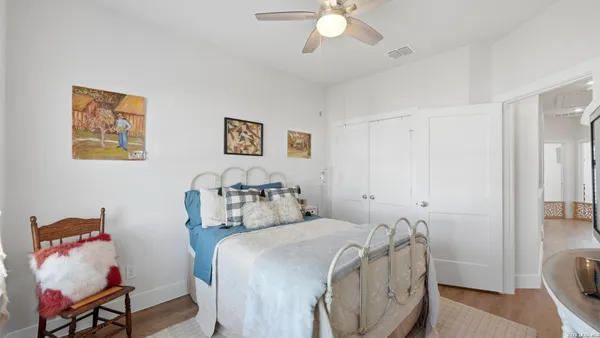a bedroom with a bed and a chandelier