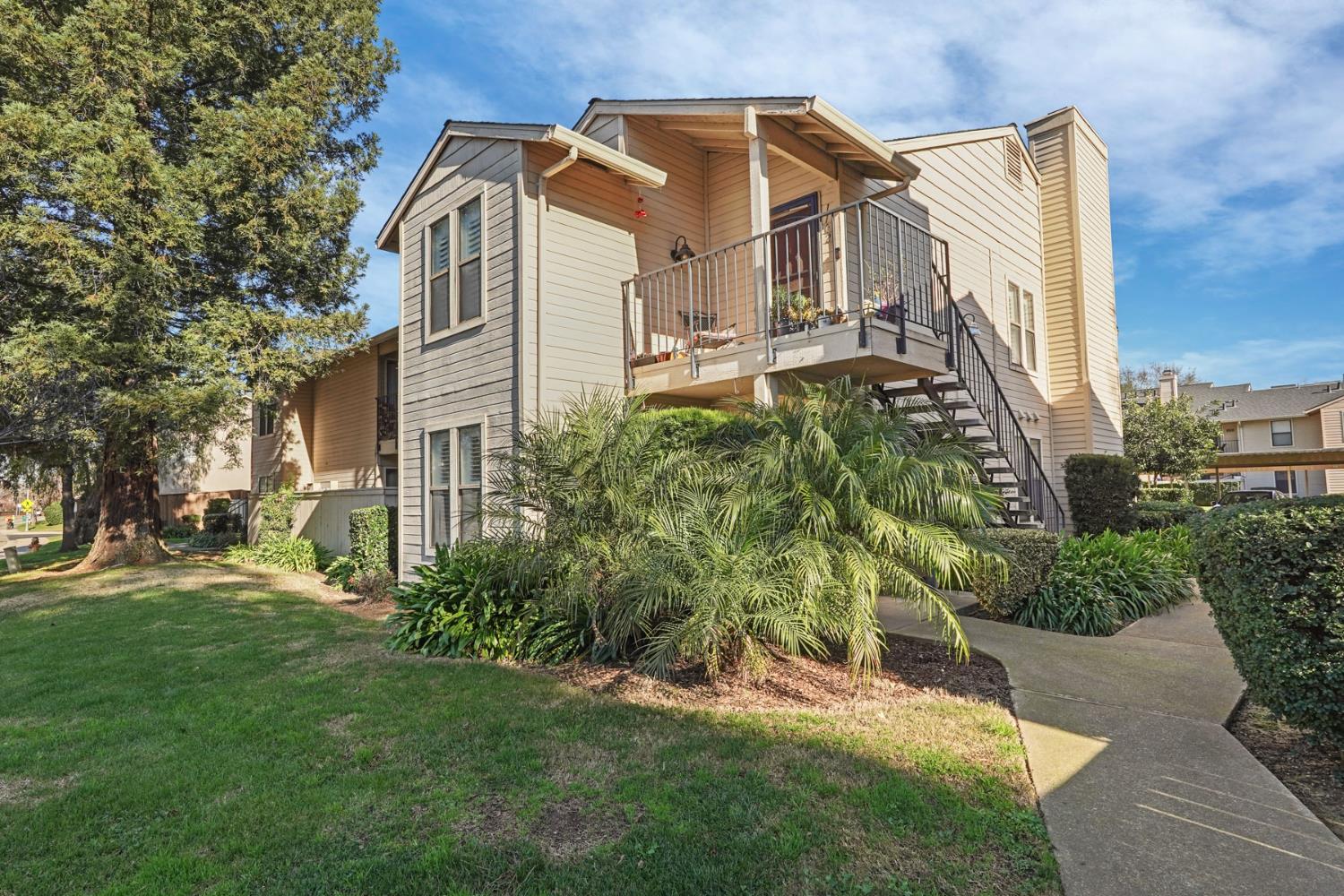 2401 Eilers Lane, Unit 1101 Lodi, CA 95242 - Photo 1 of 1 a view of a white house with a big yard and large trees