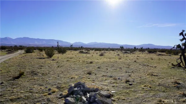 a view of a large building with beach in background