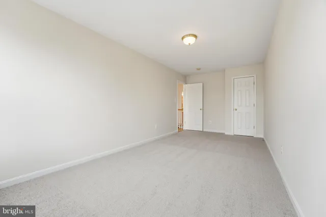 an empty room with windows and ceiling fan view