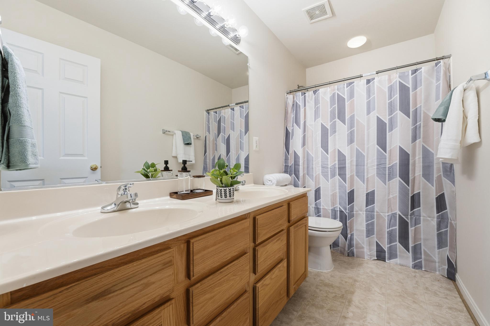 901 Woodcrest Loop Culpeper, VA 22701 - Photo 38 of 61 a bathroom with a double vanity sink toilet and shower
