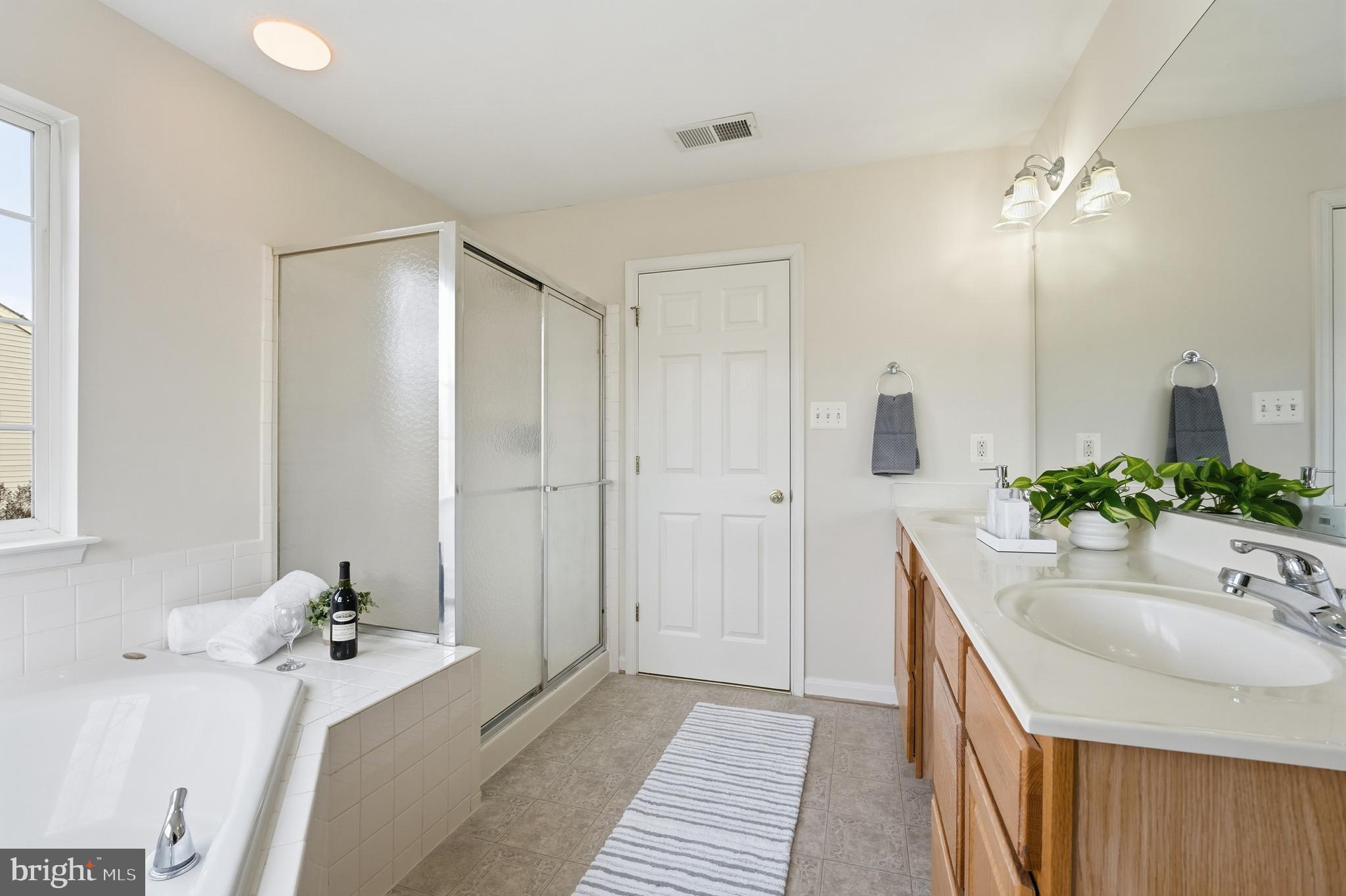 901 Woodcrest Loop Culpeper, VA 22701 - Photo 46 of 61 a bathroom with a tub sink and mirror