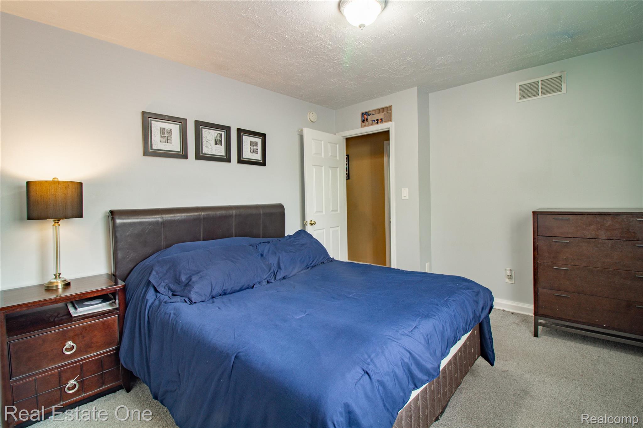 44220 Saltz Road Canton, MI 48187 - Photo 12 of 31 Bedroom featuring light gray walls and textured ceiling