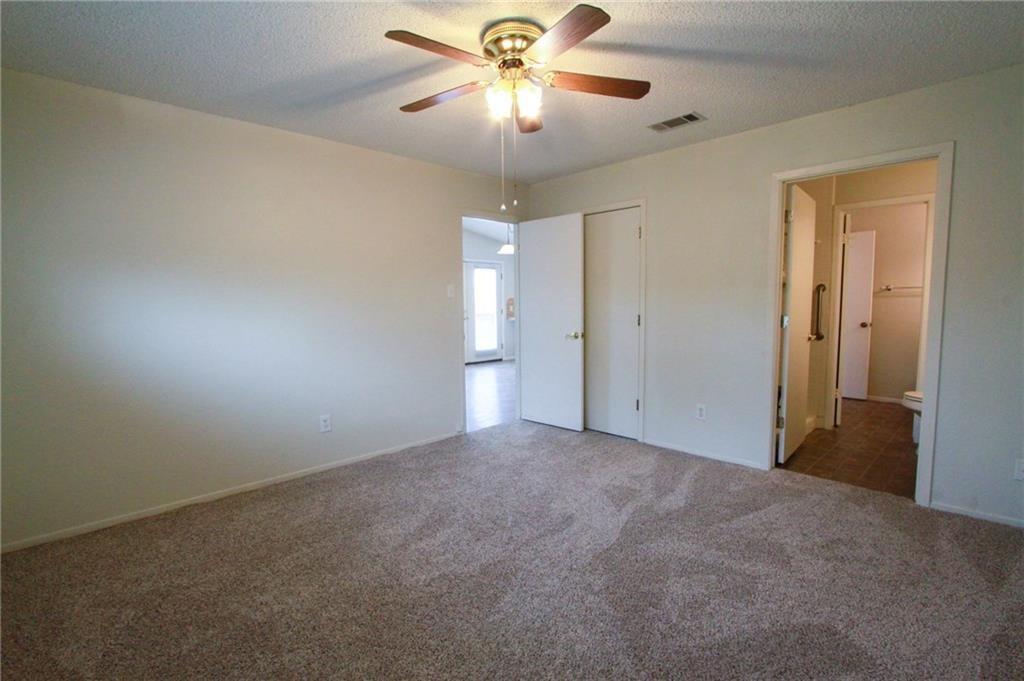 12902 Old San Antonio Road, Unit A Manchaca, TX 78652 - Photo 8 of 9 Spacious room featuring neutral carpeting and light-colored walls
