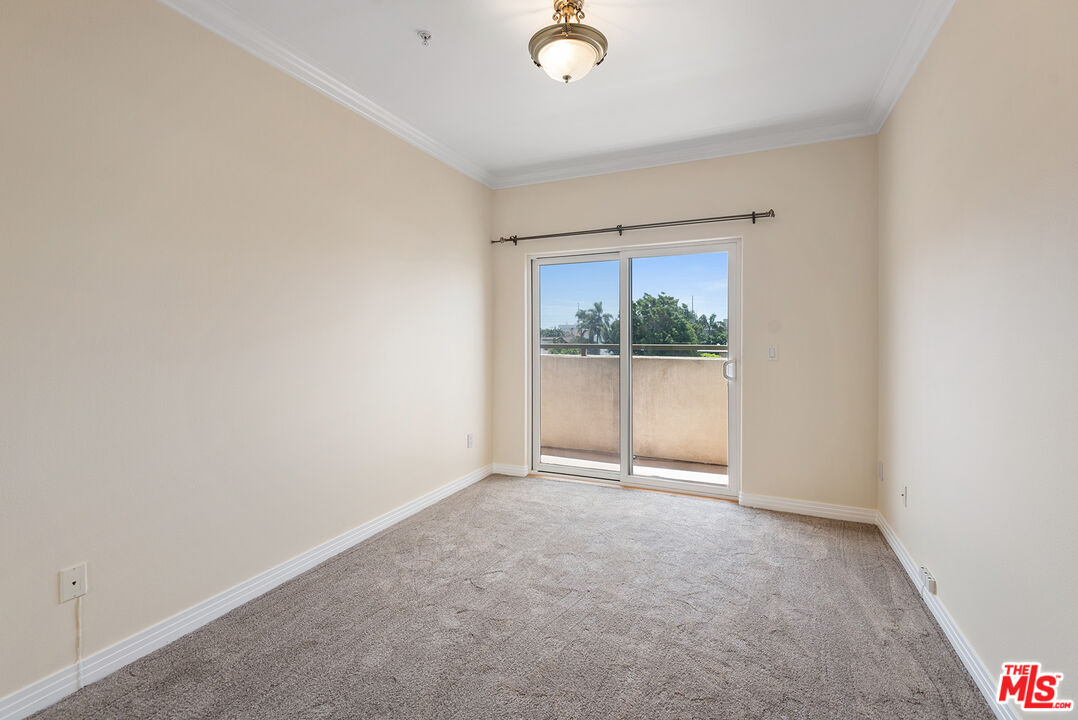 11540 Rochester Avenue, Unit 103 Los Angeles, CA 90025 - Photo 11 of 15 an empty room with windows