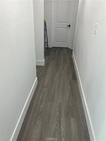 a view of a room with wooden floor