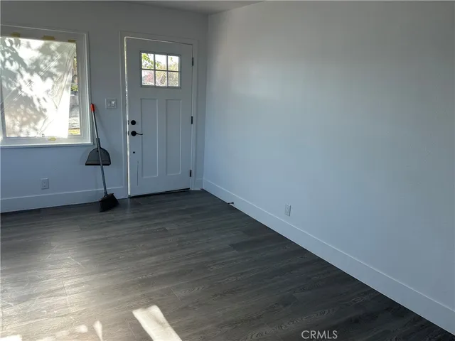 a view of wooden floor and windows in a room